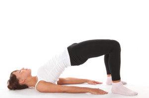 Lie down and lift up your buttocks in a Bridge pose to strengthen your liver. #Yoga