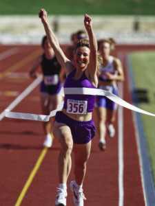 female-runner-victorious-at-the-finish-line-in-a-track-race