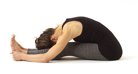 Spread your legs forward and bend down in a Seated Forward bend pose to strengthen your liver. #Yoga