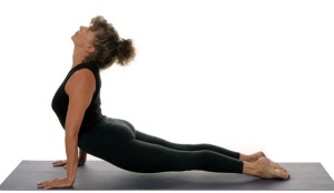 Lie down and lift up your torso in an Upward facing dog pose to strengthen your liver. #Yoga