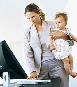 woman working and taking care of child